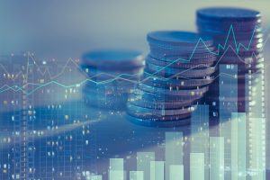 Stacks of coins overlaid with graphs, bar charts and images of illuminated buildings, symbolising property market performance.