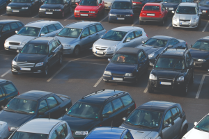 This picture shows a busy car park, with almost all of the bays full