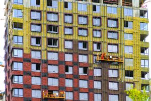Fixing building cladding