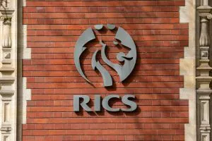 RICS emblem on the wall of its HQ - credit: Shutterstock / chrisdorney