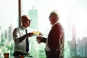 Businessmen-toast-deal-city-skyline-shutterstock_1915398598-Fit-Ztudio-scaled-e1749037884566-300x200.webp