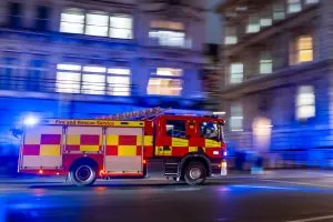 London Fire Brigade fire engine racing along a London street - credit: Shutterstock/JairoMZ