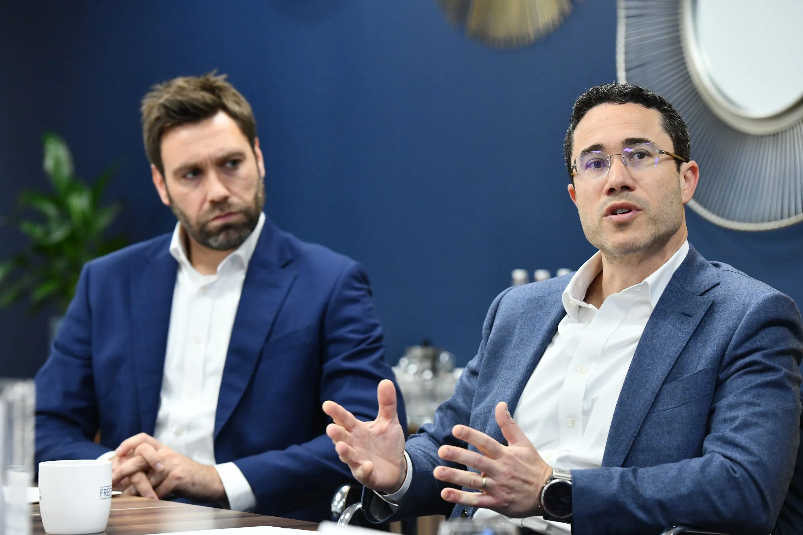 Guy Lewinsohn talking as Craig Jones listens